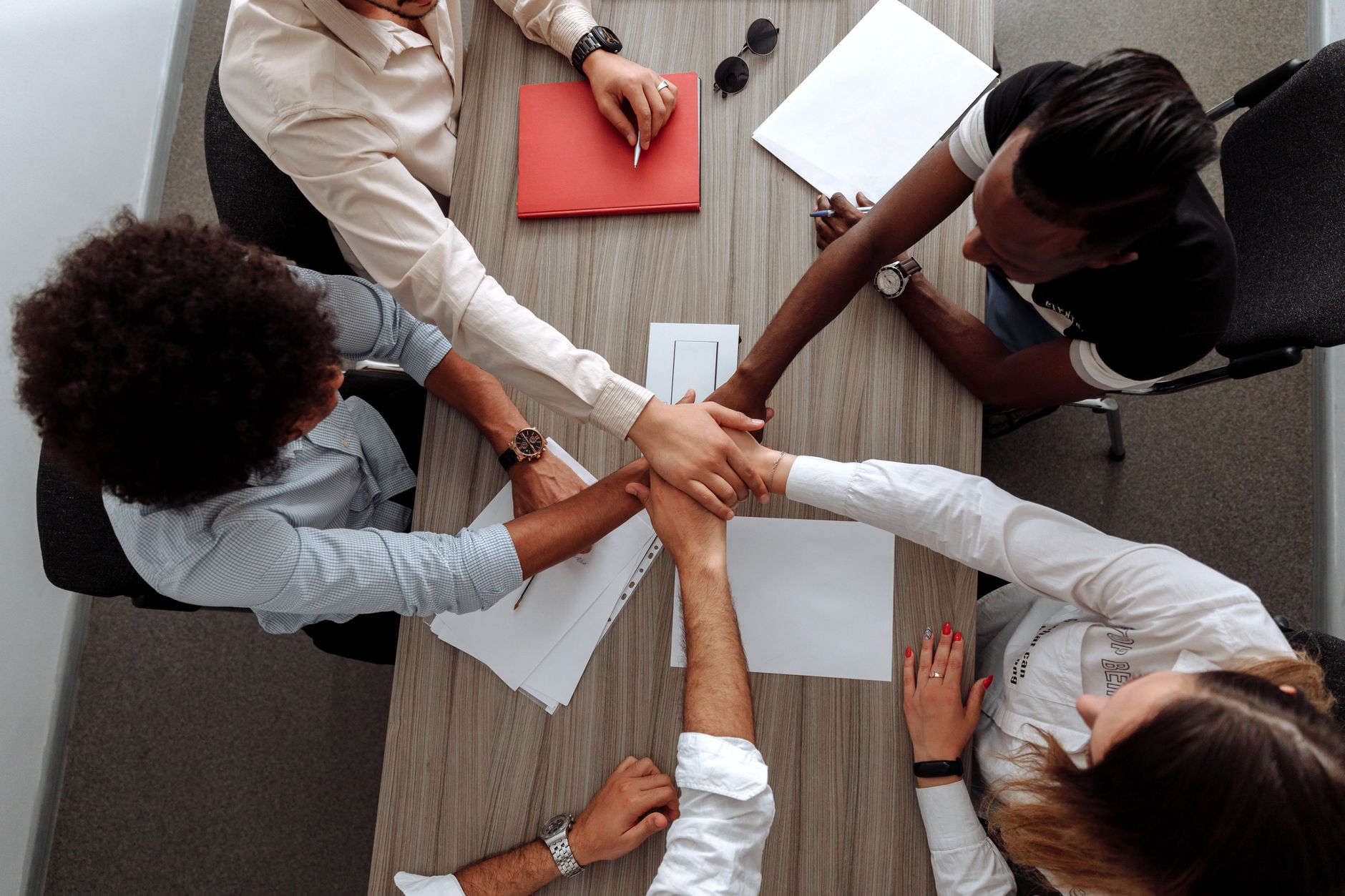 Project team collaborating around a table on a delivery plan